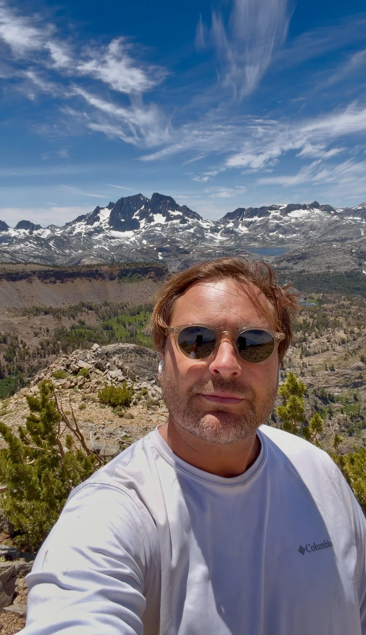Scott on Carson Peak before his fall, with mountains behind him