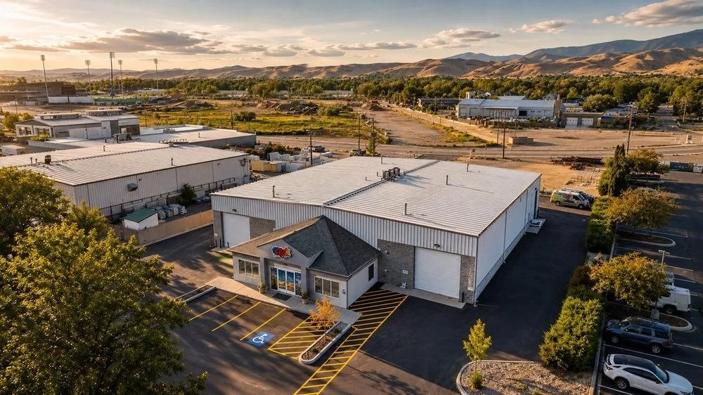 Aerial view of a commercial warehouse with the foothills behind it
