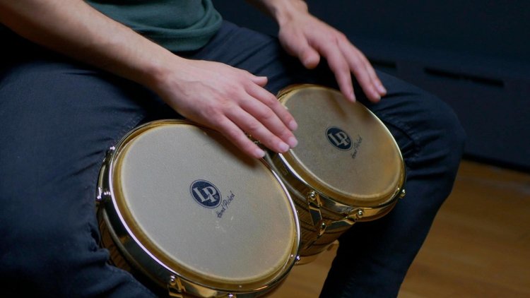 Marcos Torres playing bongos in a Bongos 101 lesson