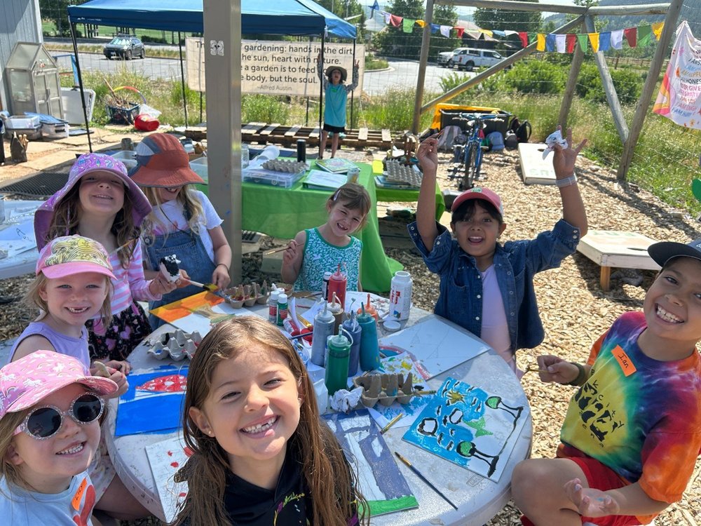 Children gathering around a garden table