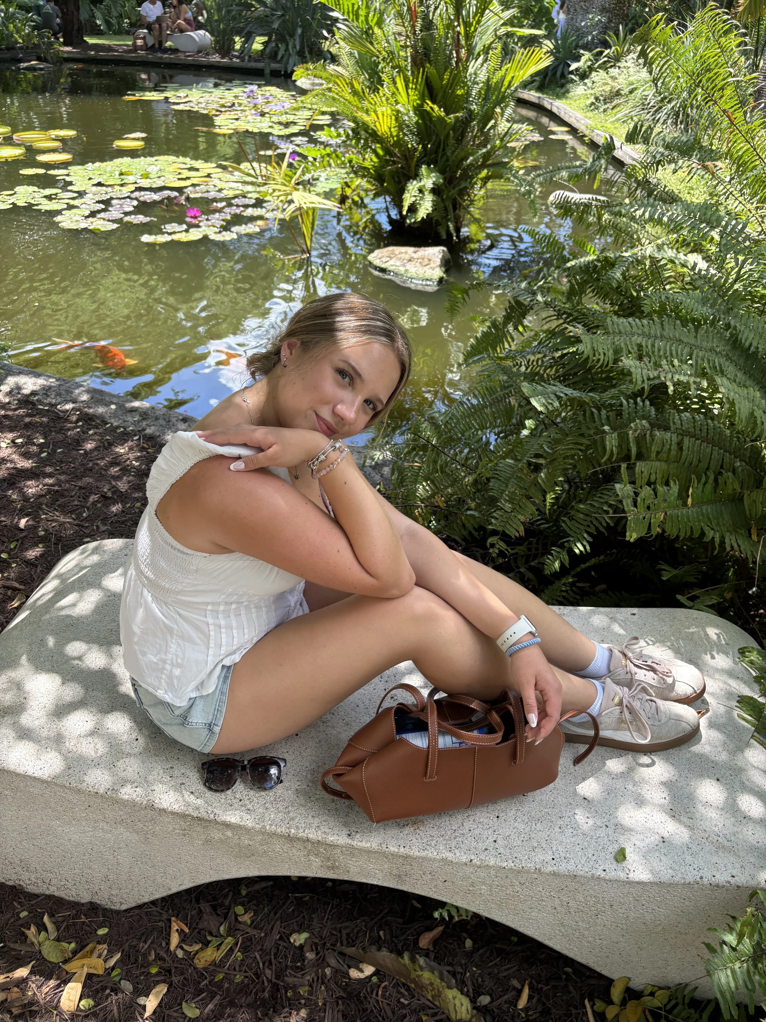 Seated portrait beside a pond in Miami
