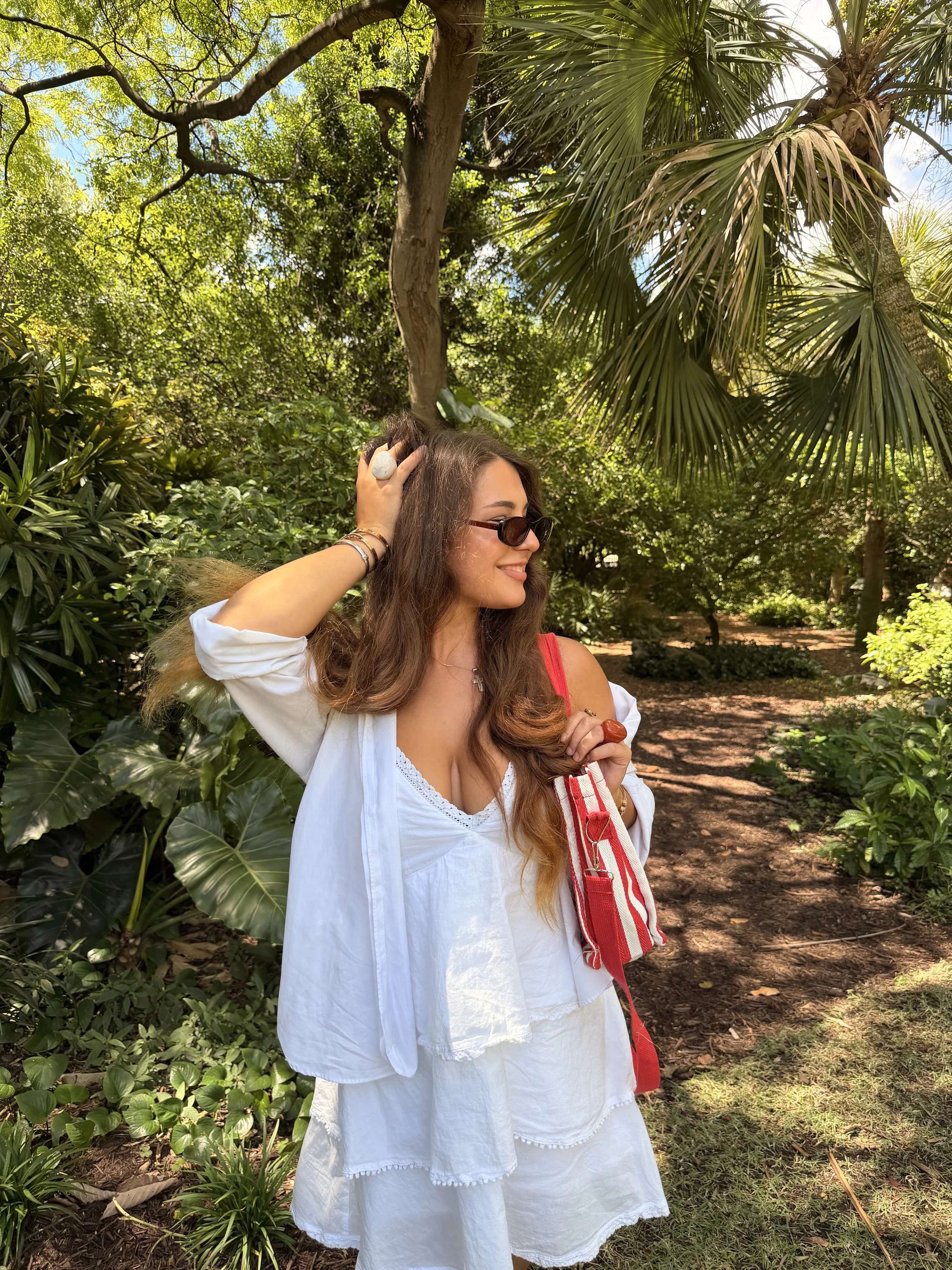 Woman in white among tropical greenery in Miami