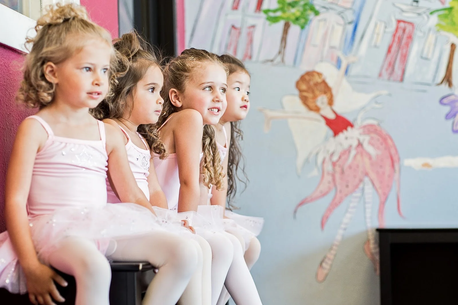 Children in dance attire participating in a structured preschool dance activity