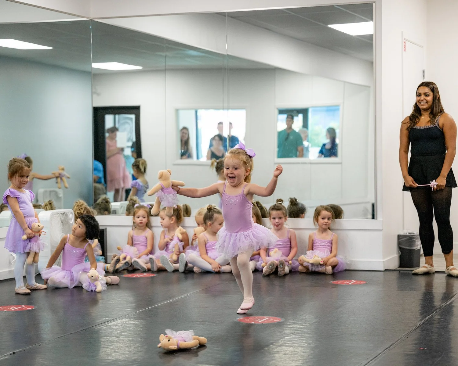 Dance teacher leading a class with systems that support studio growth