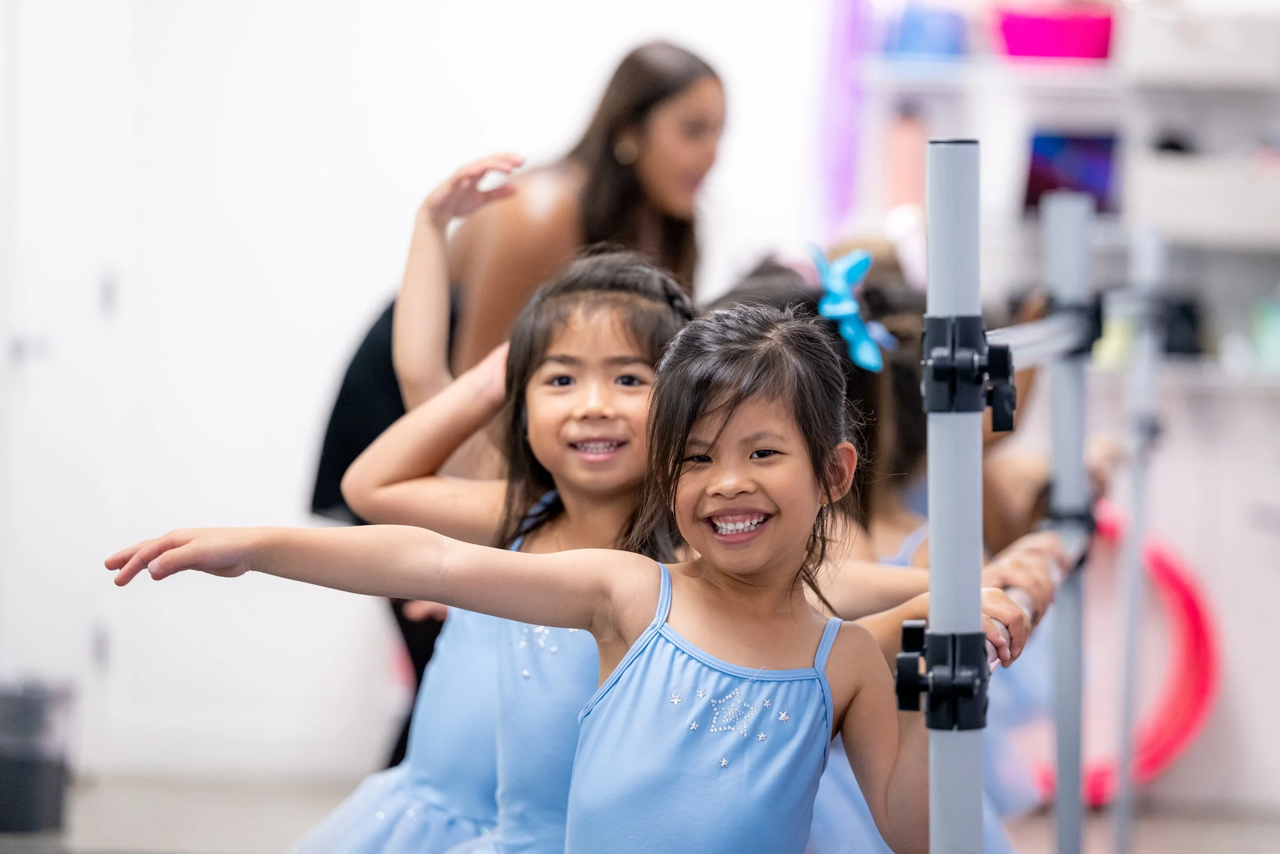 Preschool dancers participating in guided creative movement with an instructor