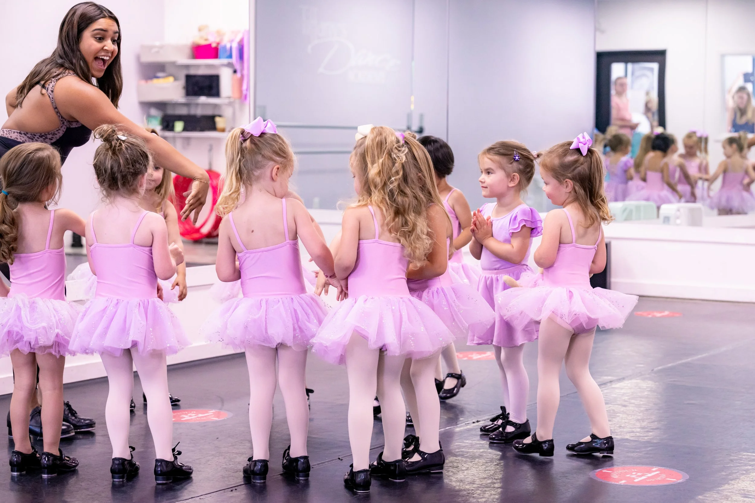 Children participating in a joyful preschool dance class guided by an instructor