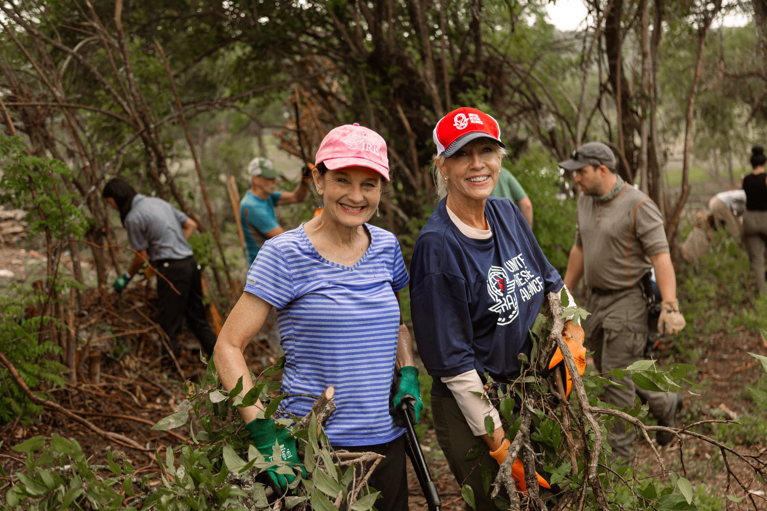 Neighbors and volunteers clearing debris together