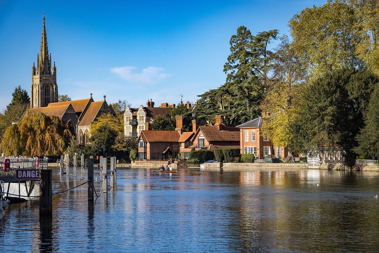 Marlow on the River Thames, with the spire of All Saints Church and riverside houses in autumn sunshine