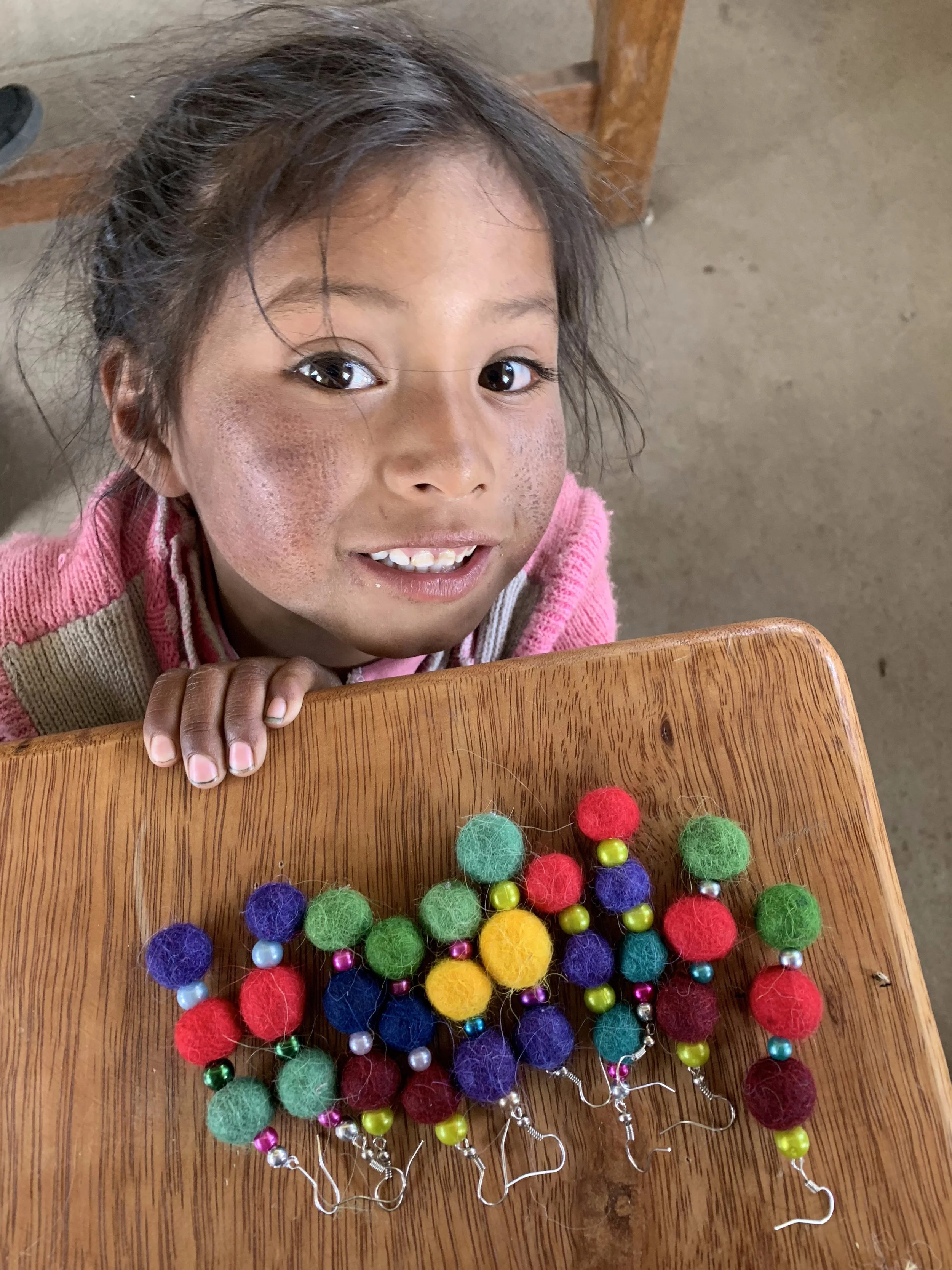 Child smiling at school desk