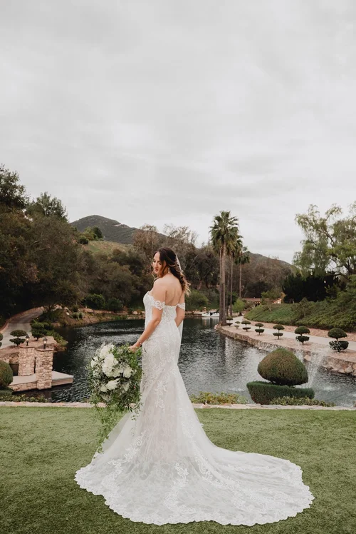 Off-the-shoulder lace fit-and-flare — gown 22.2 at a Los Angeles wedding
