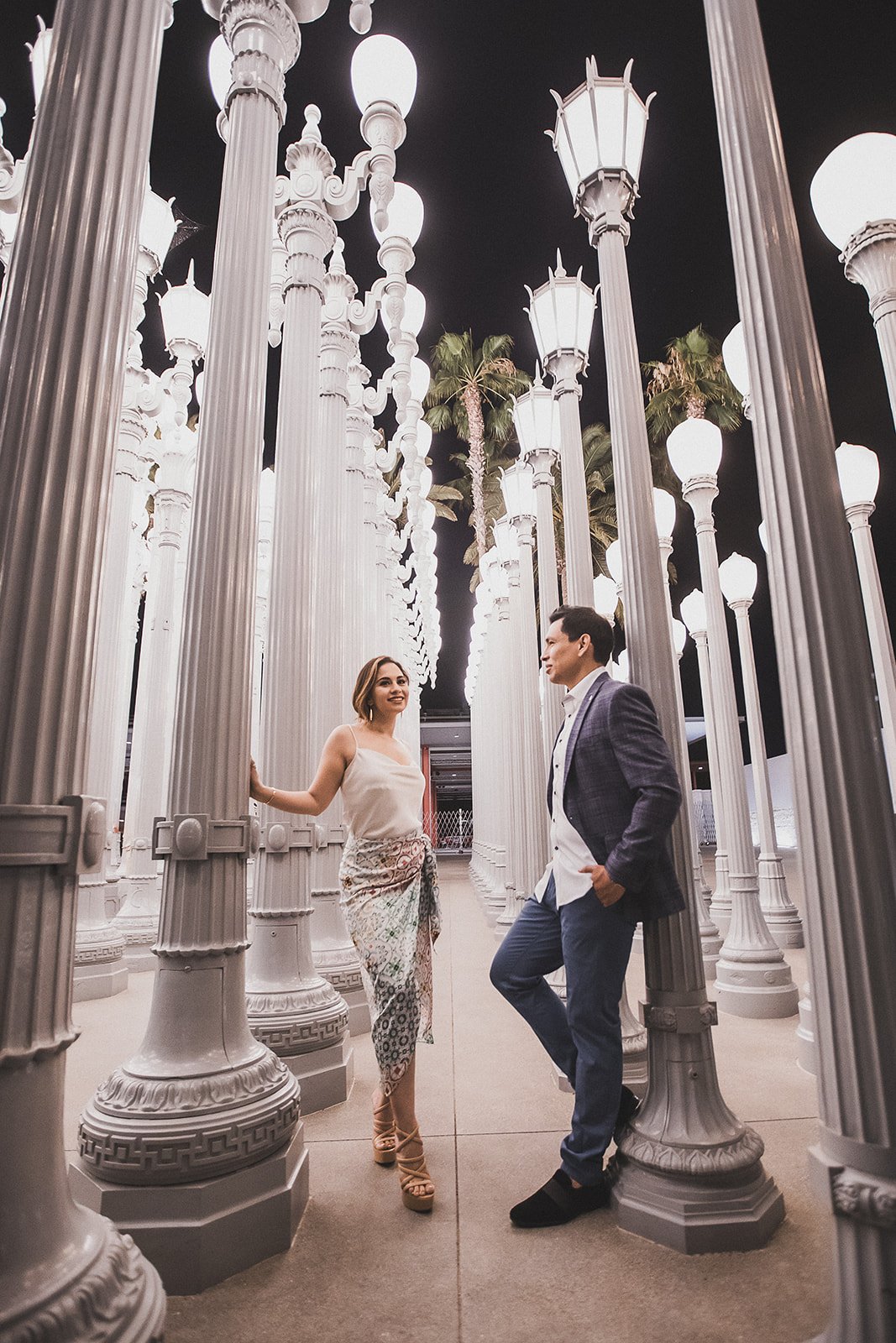 Couple dancing among the restored street lamps of Urban Light at LACMA