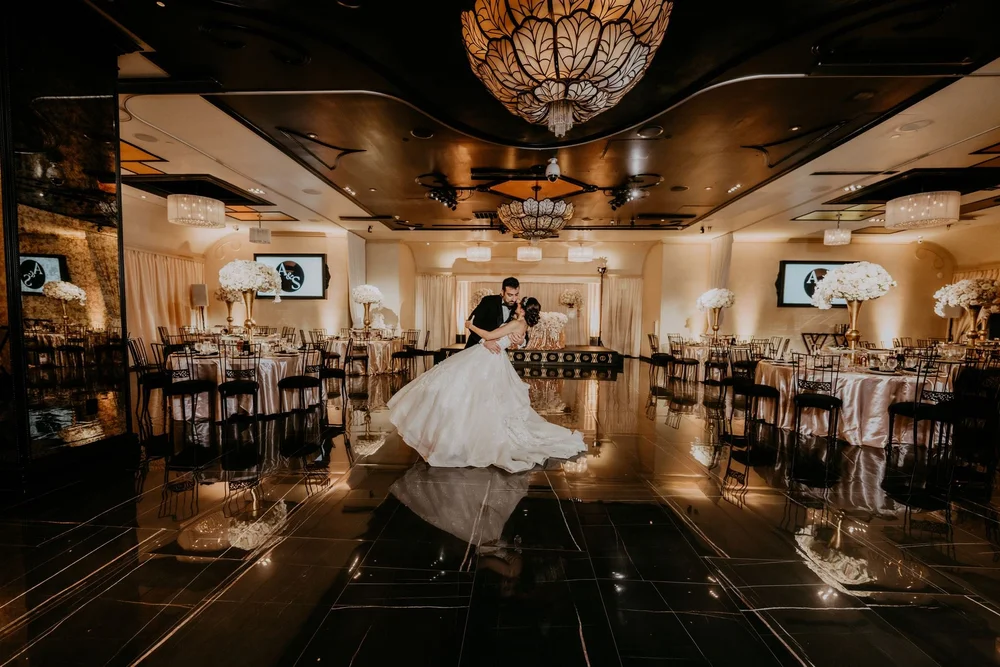 Groom dipping the bride on the mirrored dance floor at NOOR