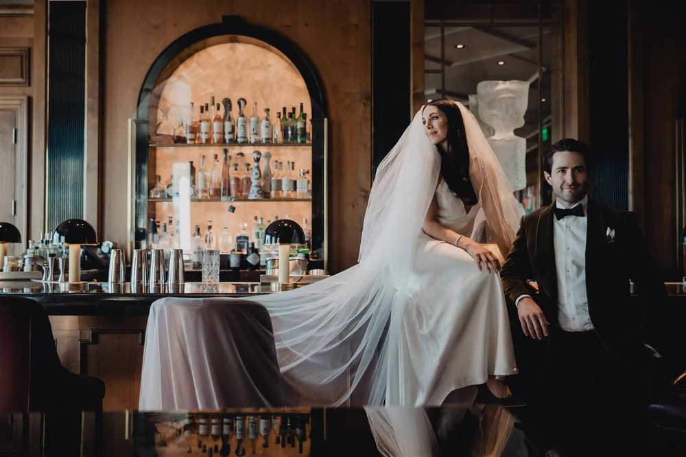 Bride and groom at the arched back bar of the Manor Bar at Rosewood Miramar Beach