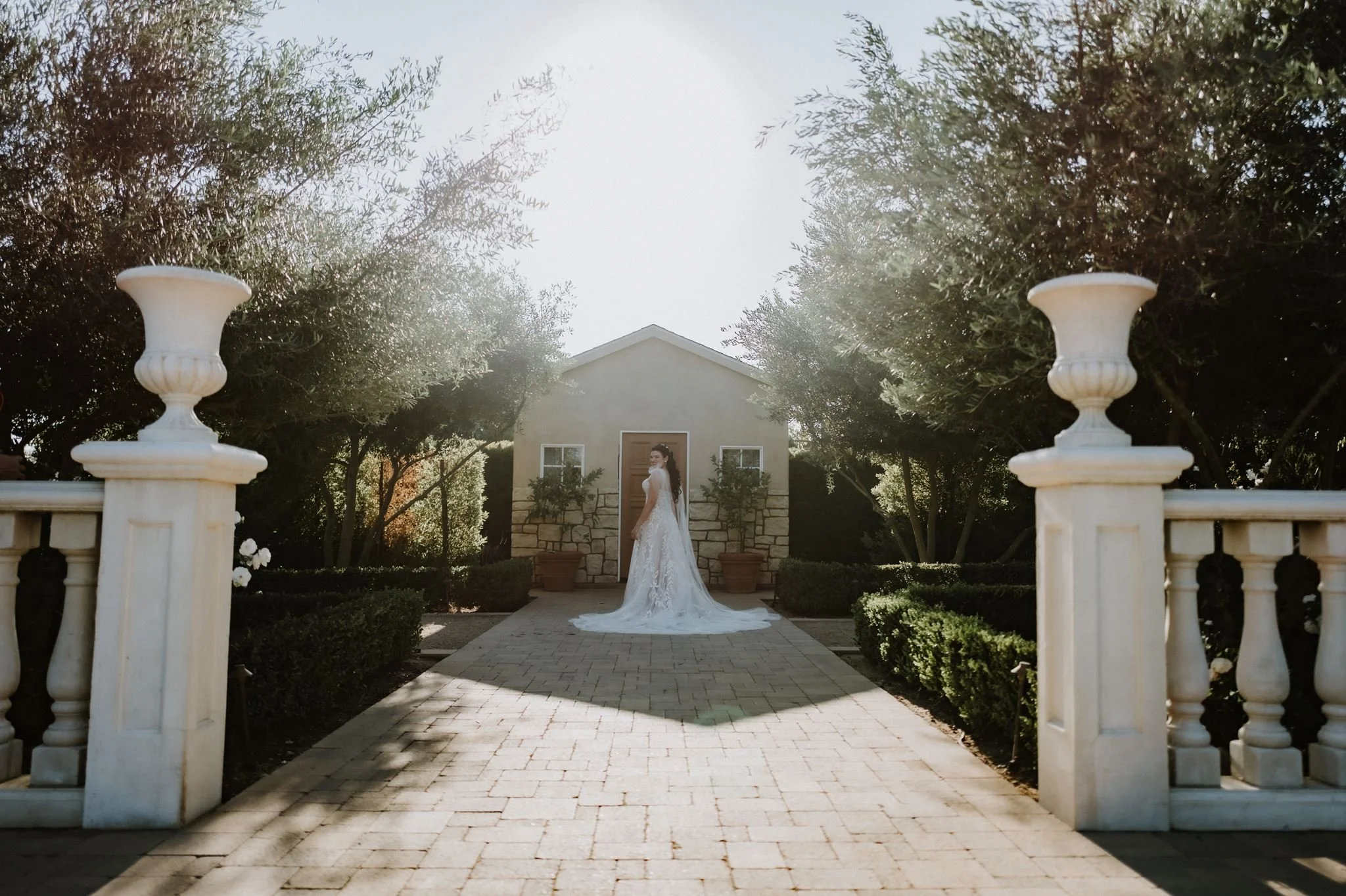 White pavilion at the end of the formal path at Tuscan Rose Ranch in Santa Paula