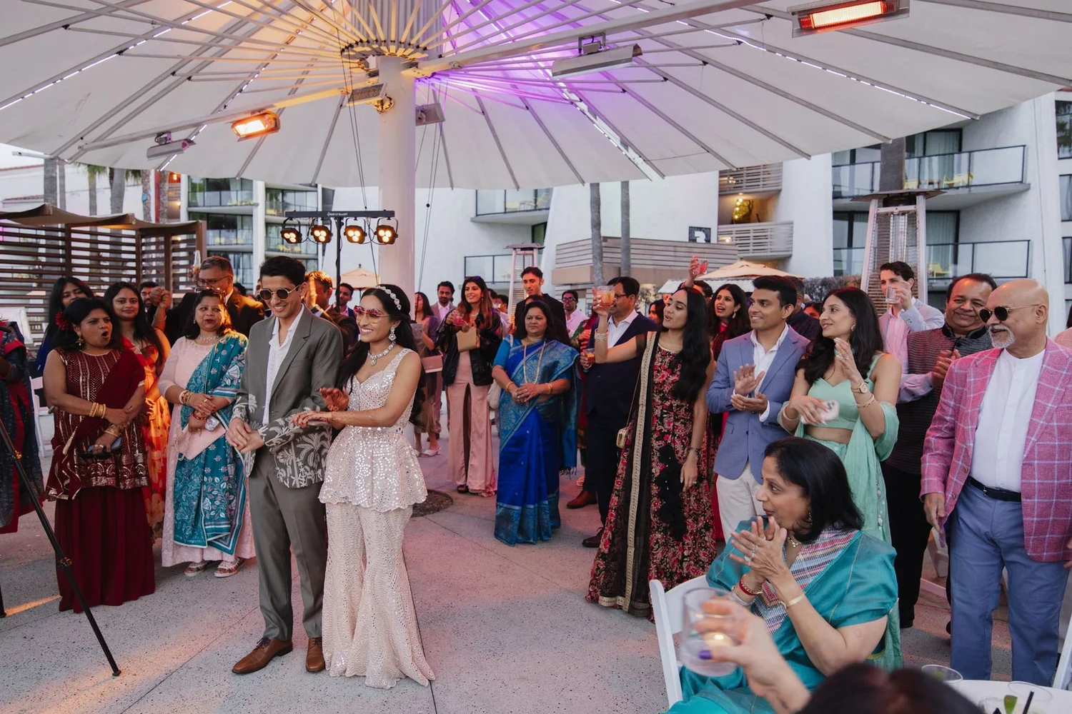 Guests gathered around the couple under a canopy tent at Hotel Maya