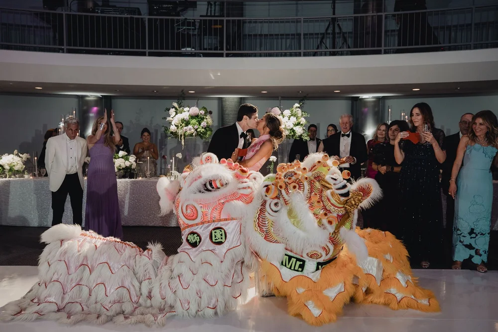 Two lions resting on the dance floor as guests watch from the balcony above
