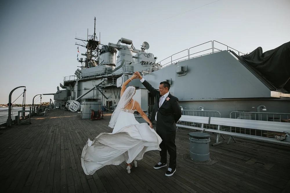 Bride’s dress catching the wind on the Queen Mary’s sun deck beside the forward gun turret