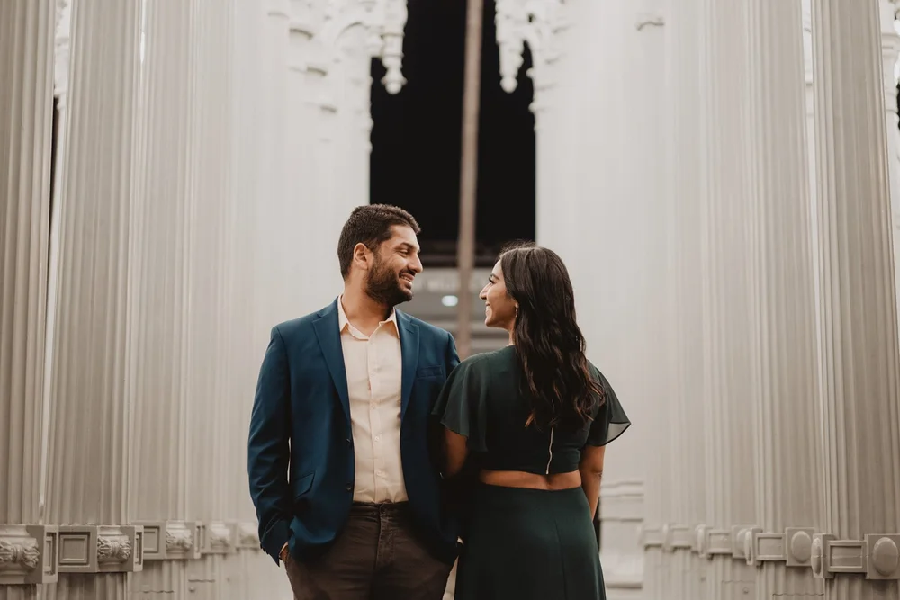 Couple facing each other at dusk on the LACMA campus in Los Angeles