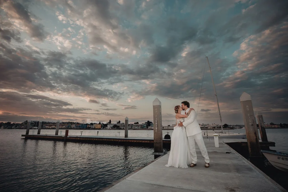 Couple on the dock at Bali Hai on Shelter Island under a dramatic sky