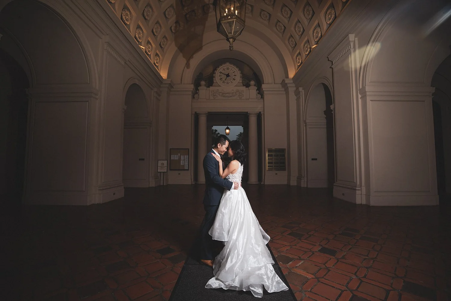 Bride and groom dancing together in an arched doorway at Pasadena City Hall