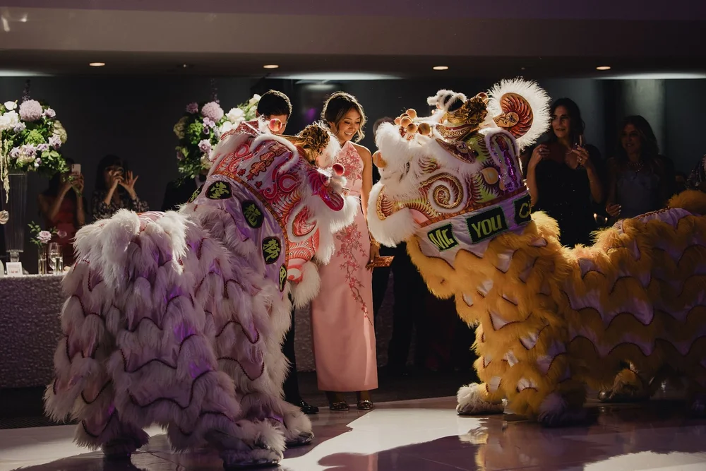 Bridal party surrounded by two lions on the reception dance floor