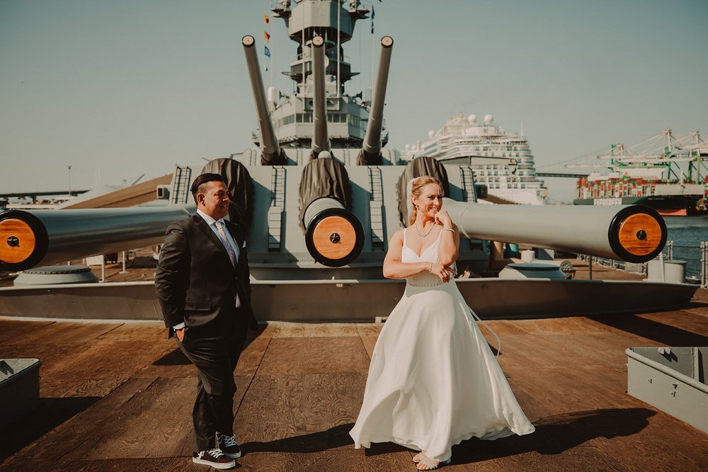 Bride and groom standing together on the teak deck of the Queen Mary in Long Beach