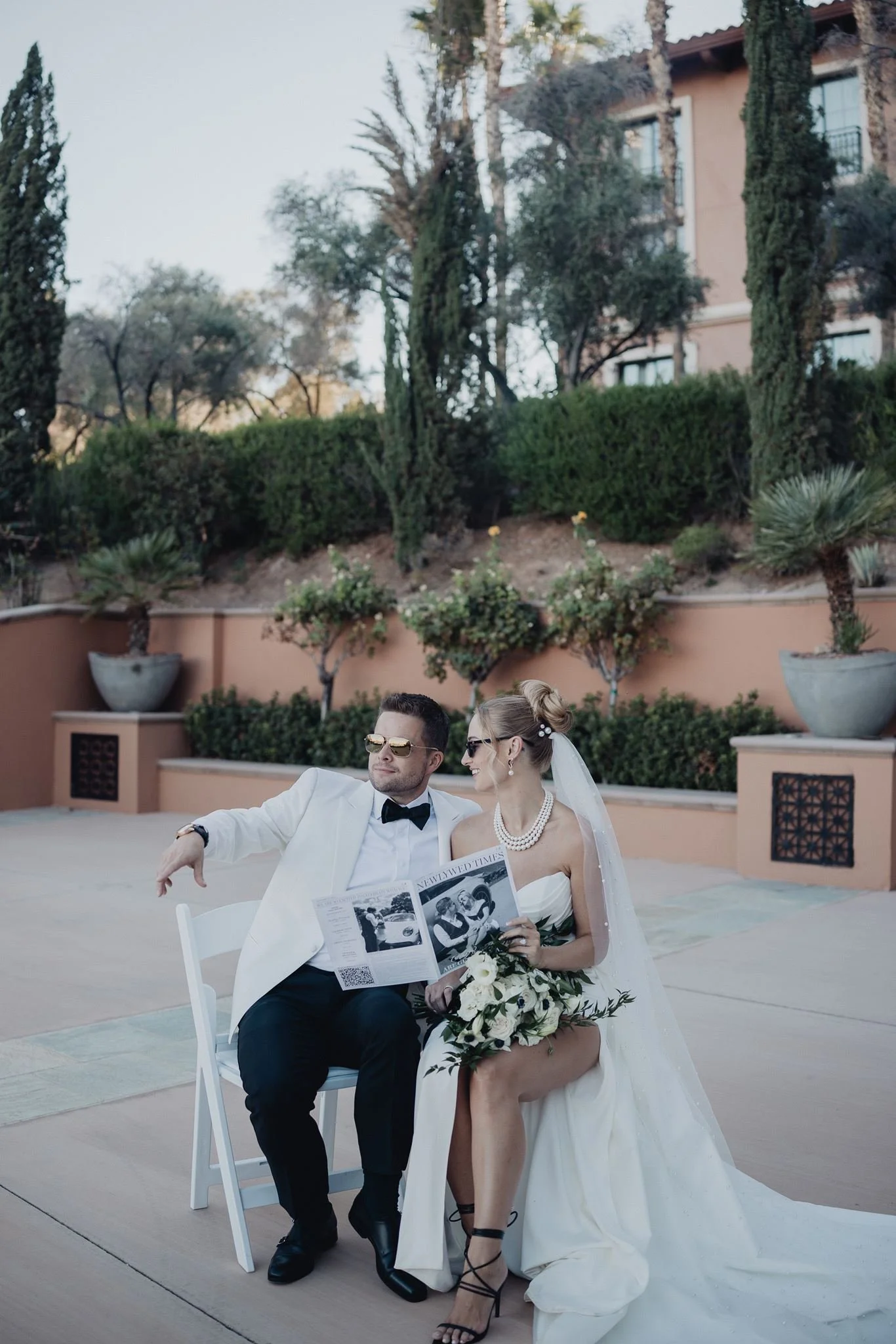 Couple sharing a note on terracotta-colored terraces with cypress and hillside gardens at Westin Lake Las Vegas