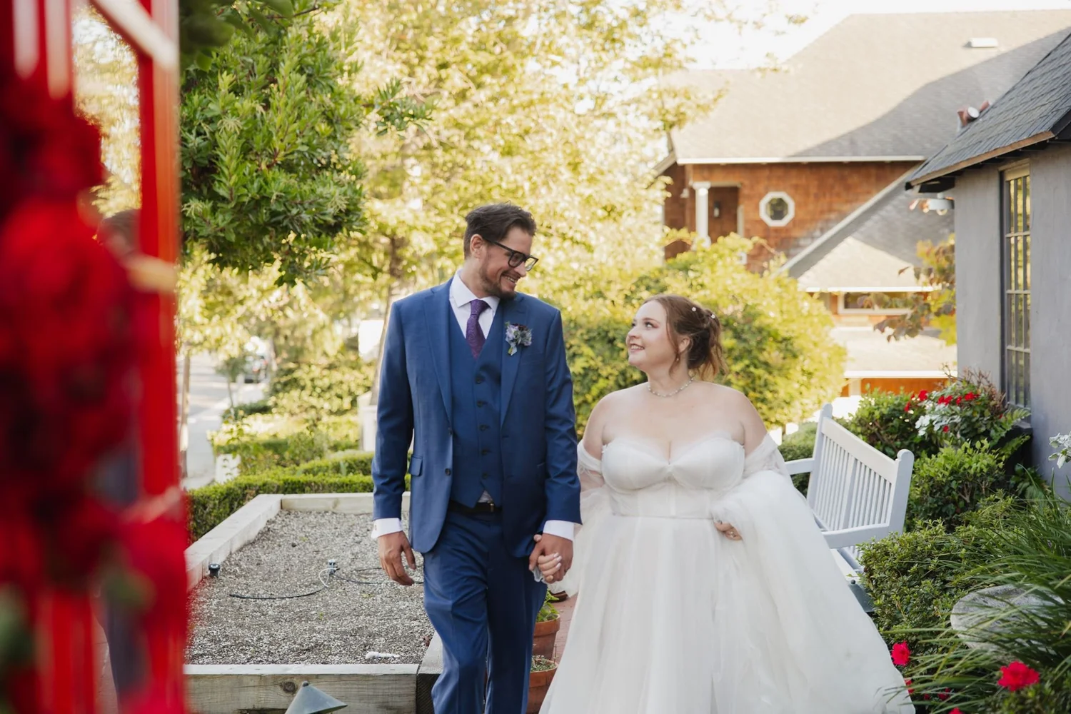 Couple smiling at each other on the garden path at Five Crowns, Corona del Mar