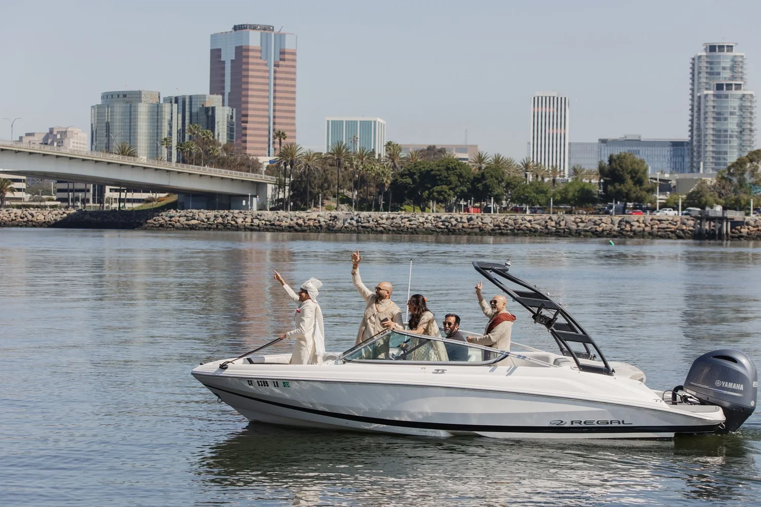 Couple arriving by boat with the downtown Long Beach skyline behind them
