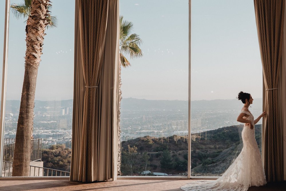 View west over the San Fernando Valley at sunset framed by the terrace drapes at Castaway Burbank