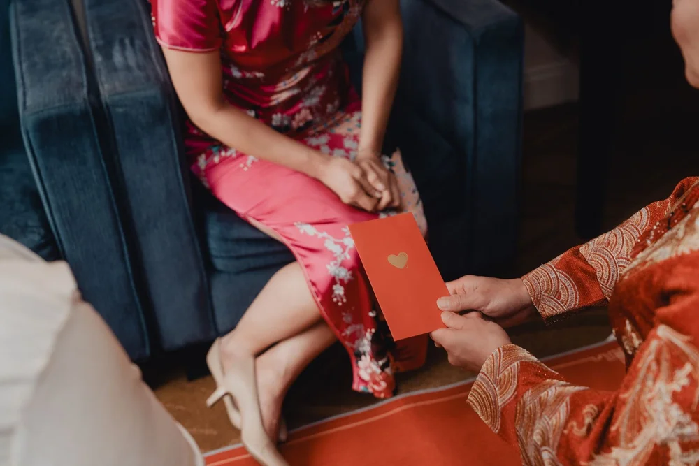 Red envelope passed to the bride after she serves tea to an elder