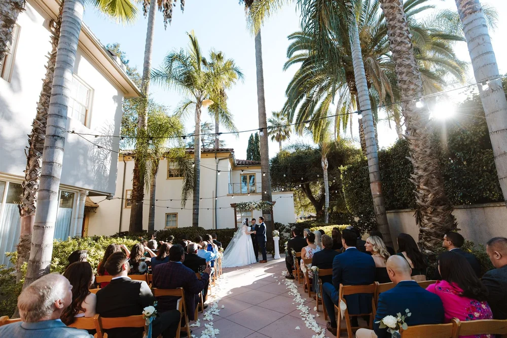 Outdoor palm-lined ceremony at The Maxwell House in Pasadena, guests seated beneath string lights