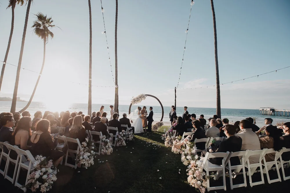 Oceanfront lawn ceremony at Scripps Seaside Forum with the pier on the horizon