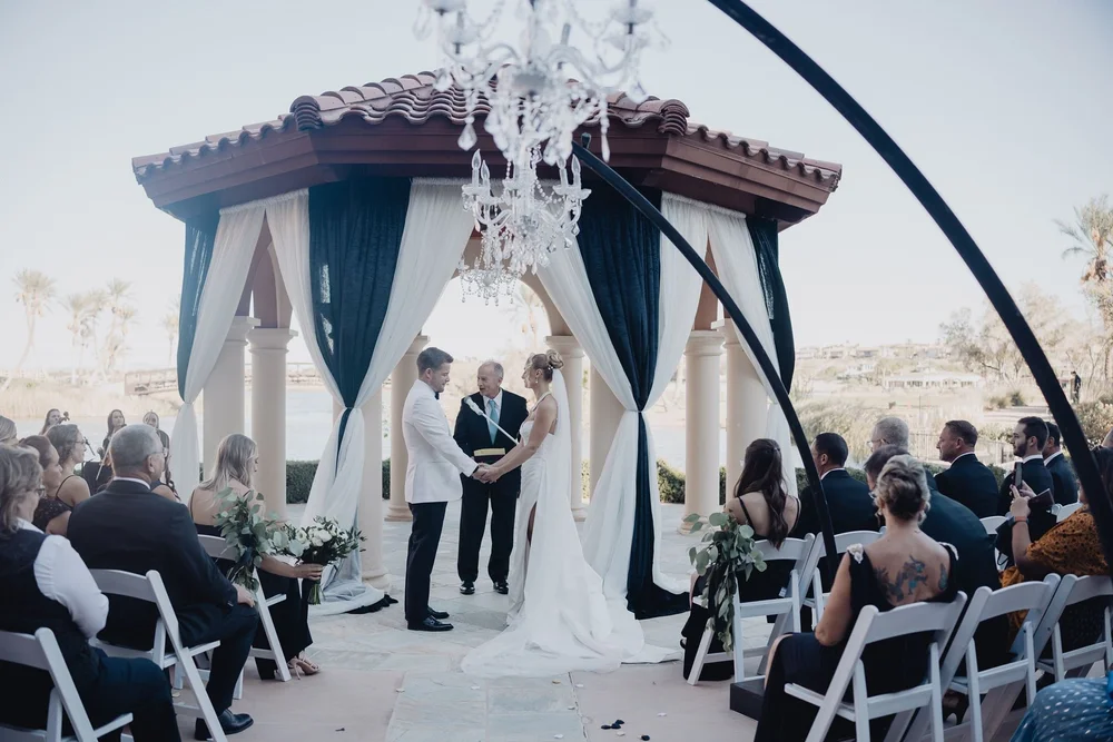 Ceremony under the domed gazebo with navy drapes and a chandelier at Westin Lake Las Vegas
