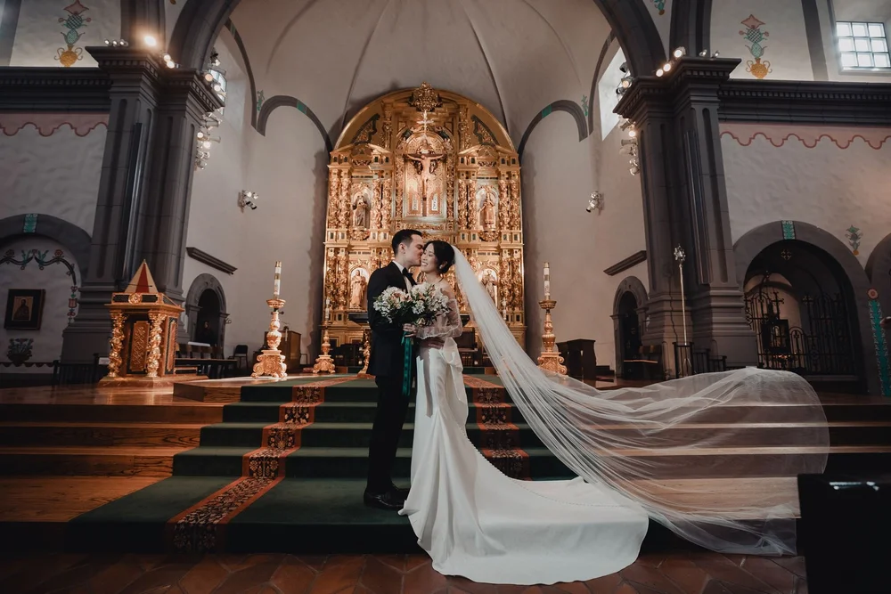 Soaring stone arches and gold Grand Retablo altar inside Mission Basilica San Juan Capistrano