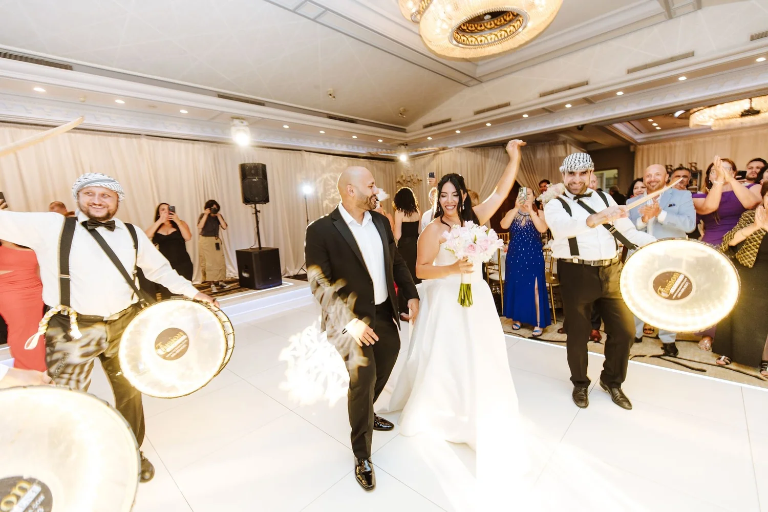 Couple entering to drummers with dhol-style drums at Glenoaks Ballroom in Glendale