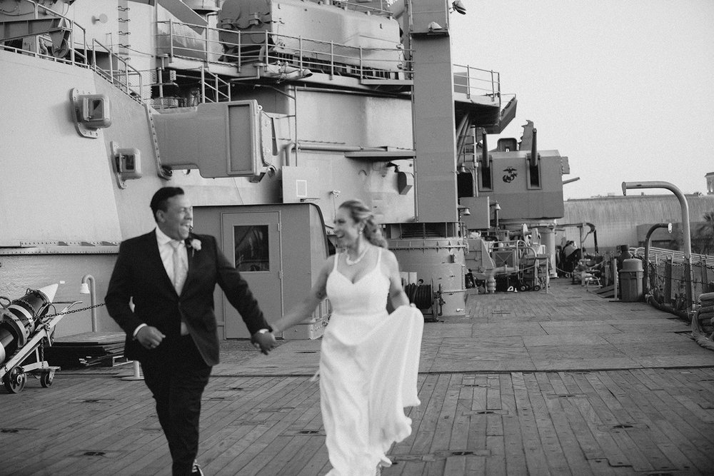 Black and white photograph of the couple walking and laughing along the promenade deck