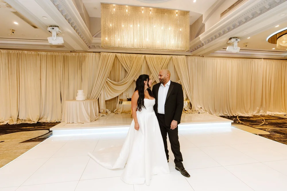 Couple on the white dance floor of the draped ballroom at Glenoaks Ballroom in Glendale