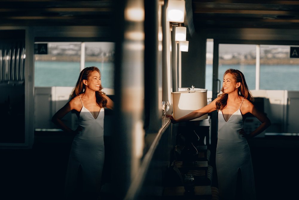 Bride in window light reflected in a mirror aboard a FantaSea yacht