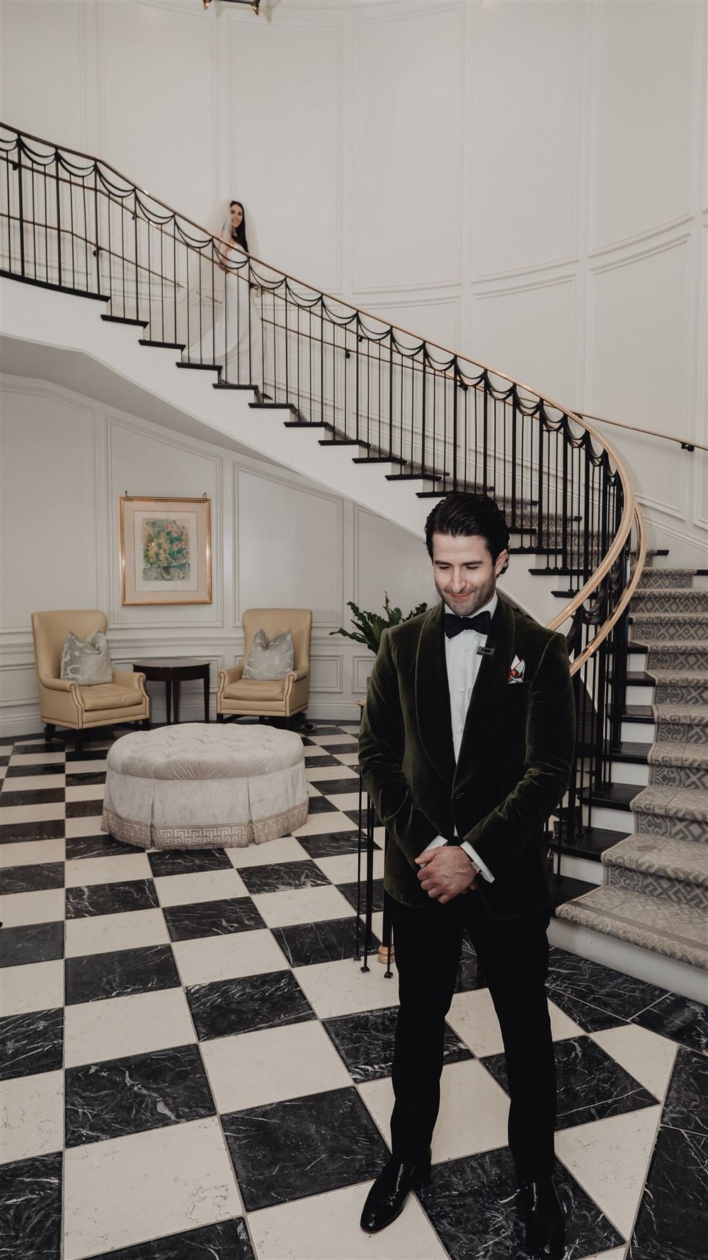 The curved Manor House staircase at Rosewood Miramar Beach, seen wide with the bride part of the way down
