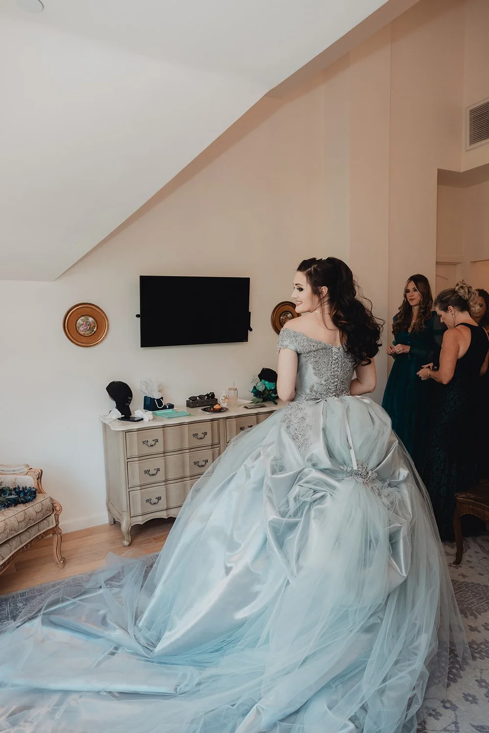 Bride turning in a pale blue layered tulle ball gown so the skirt fans wide across a bright room