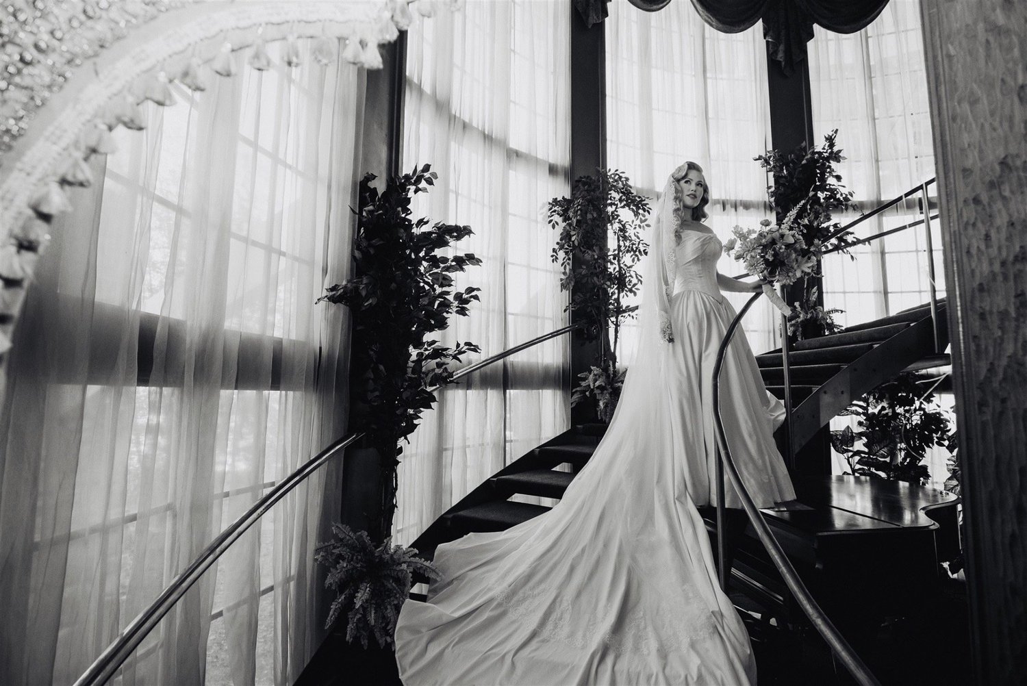 Black and white portrait of the bride on the spiral staircase at the Madonna Inn, San Luis Obispo