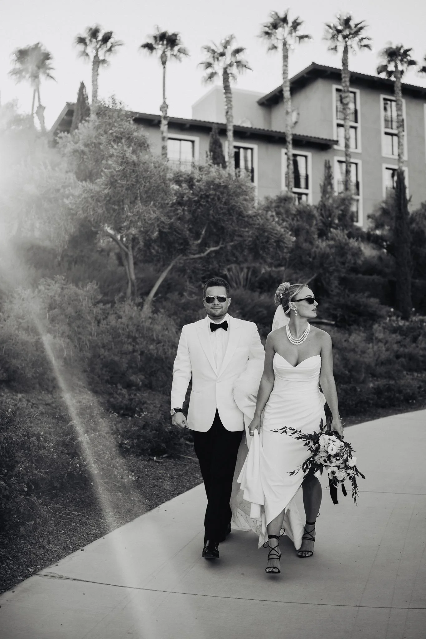 Couple walking the garden path below the Mediterranean-style resort at Westin Lake Las Vegas, black and white