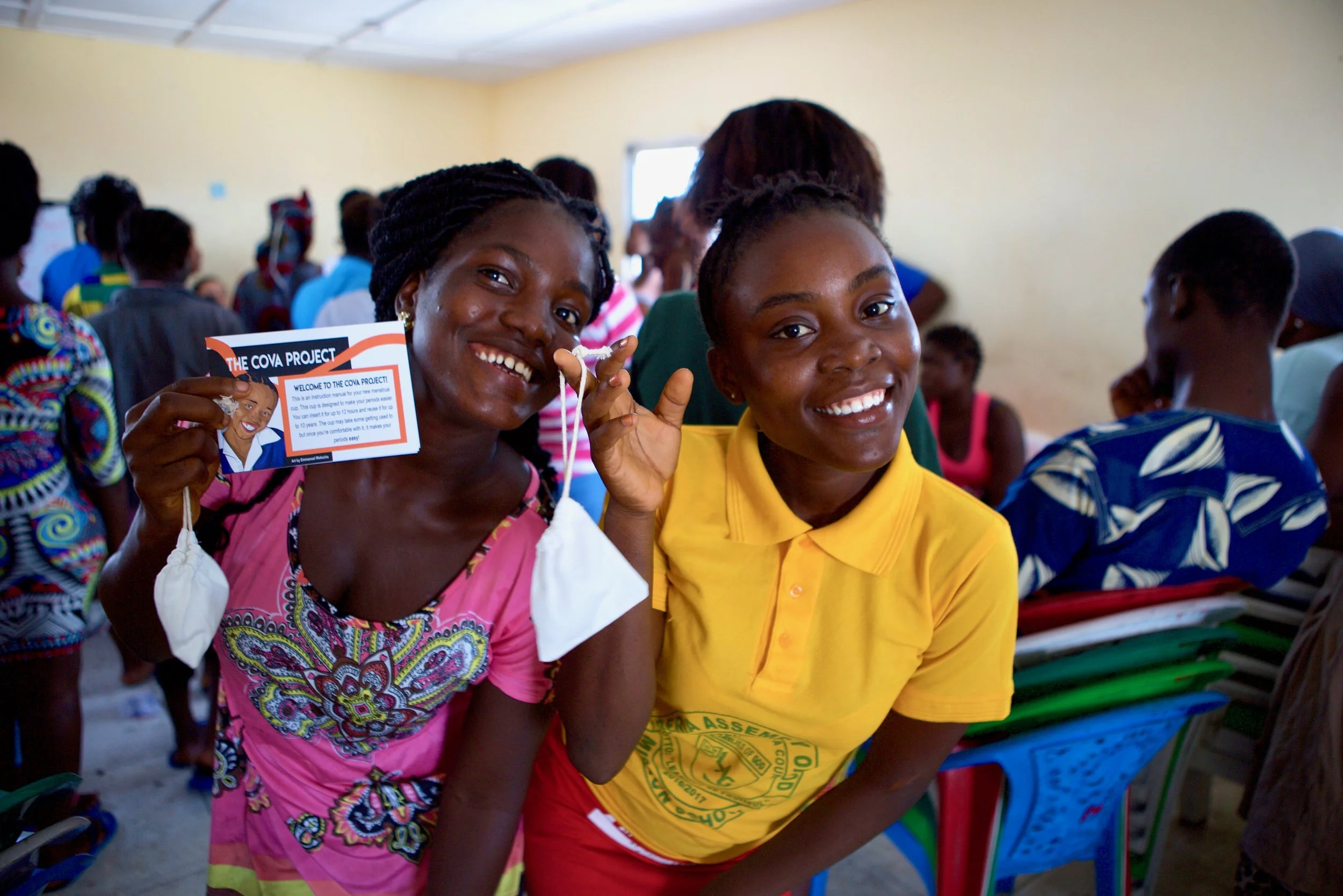 Girls smiling with menstrual cups after taking part in The Cova Project programme