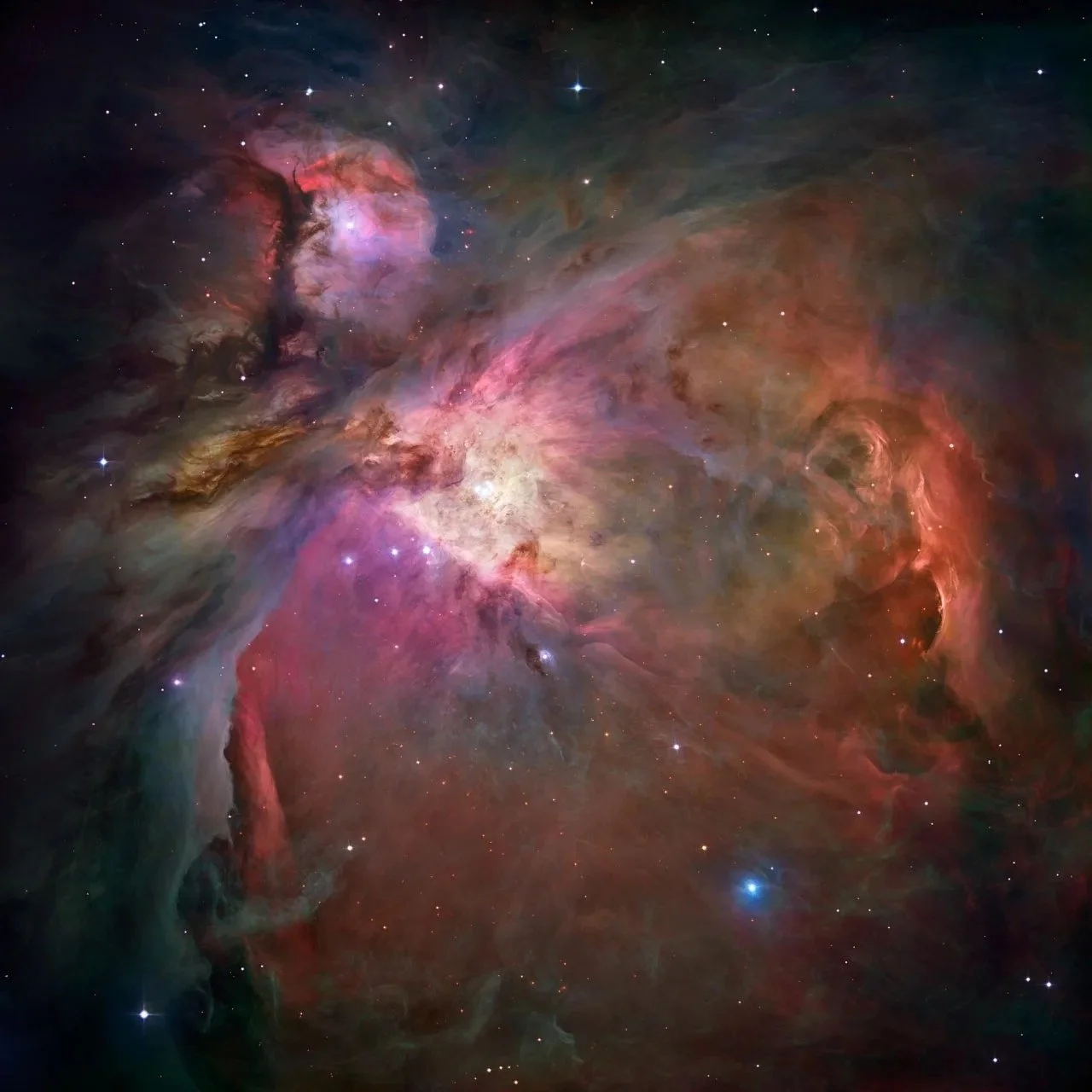 Five-filter Hubble mosaic of the Orion Nebula, showing glowing gas, dust, young stars, and sweeping red, pink, blue, and green structures.