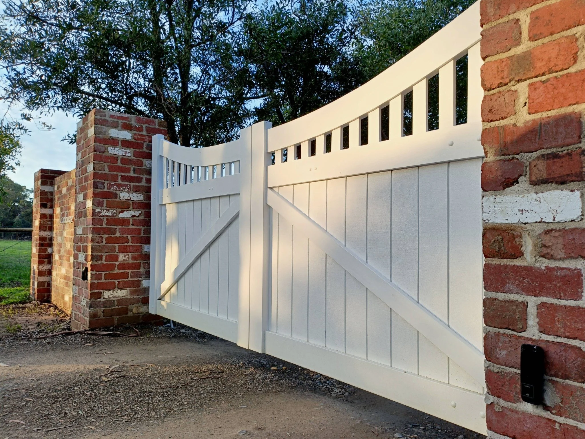 White painted double timber gates installed with automation