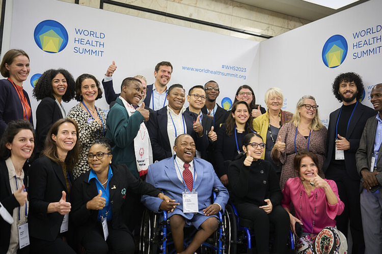 Members of the disability-inclusive health consortium posing after their session with Ilona Kickbusch, Founding Director of WHS.