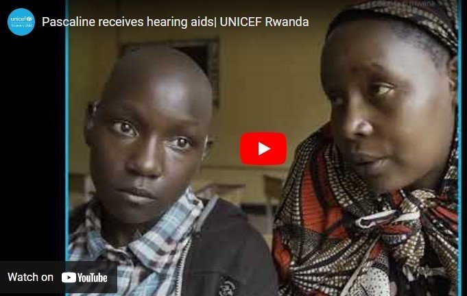 Screen shot from a short YouTube video made by UNICEF Rwanda with a young girl Pascaline and her mother side by side. Pascaline has just tested her new hearing aids