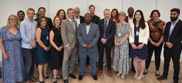 Group photograph of the ATscale Board and members of the ATscale Secretariat. Standing together at UNOPS offices in Geneva
