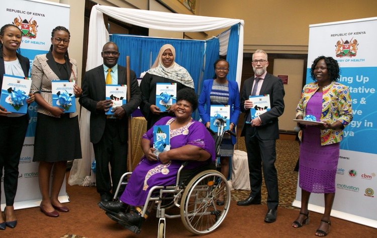 Photograph of staff from the Ministry of Health in Kenya, with ATscale CEO Pascal Bijleveld at the launch event in Nairobi.  Sitting in front is Dr. Agnes Mithamo, a peadetrician in an wheelchair
